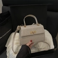 Champagne gold glitter handbag with trapezoid structure and gold rotating lock in a gift box - Gold