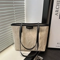 Large beige pleated tote bag with black trim and Fashion label in a modern setting - Khaki