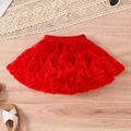 Flat lay of red layered tutu skirt with elastic waistband and fashion accessories - Red