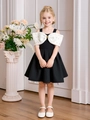 Elegant girls' A-line dress in black and white with a large bow and gold bead accents - Black / 90cm-3Y
