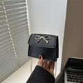 Mini black shoulder bag with a gold bow buckle and chain strap for women - Black