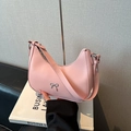 Pink hobo underarm bag with silver metal bow detail and smooth leather texture - Pink