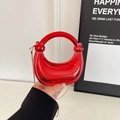 Glossy bright red crescent-shaped handbag with a large ring handle and gold chain strap - Red