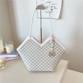 Minimalist beige monogram tote bag with V-shaped top and gold M pendant on stand - White