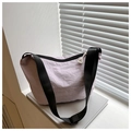 Detail of lavender nylon dumpling bag showing waterproof texture and wide strap - Purple