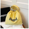 Yellow drawstring bucket bag with Beach lettering and wide adjustable shoulder strap - Yellow