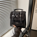 Fashionable black mini backpack with floral texture, bow, and heart charm for women - Black