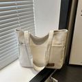 Minimalist off-white canvas tote bag with front zipper pocket and side storage - White