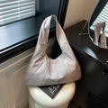 Silver-grey hobo shoulder bag with distressed metallic texture and paneled design - Light Gray