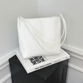 Minimalist white PU leather tote bag with vertical stitching on elegant book prop - White