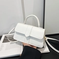 Minimalist white faux leather crossbody bag with rounded handle and flap closure - White