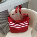 Red canvas shoulder bag with white stripes and wide adjustable strap for casual travel - Red