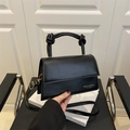 Classic black handbag with trendy knotted handles and adjustable shoulder strap for women - Black