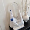 Minimalist creamy white large canvas tote bag with black embroidery and blue charm - White