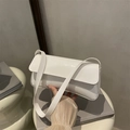 Chic white patent leather underarm bag with glossy finish and minimalist shoulder strap - White