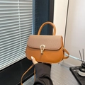 Brown woven flap crossbody bag with golden horseshoe buckle and tassel detail - Brown