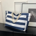 Blue and white striped canvas tote bag with cotton rope handles and side pockets - Blue