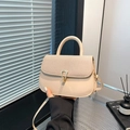Apricot crossbody bag featuring woven texture flap and gold-tone geometric metal clasp - Khaki