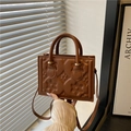Caramel brown vintage crossbody bag with floral star embossing and dual top handles - Brown