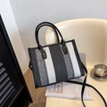 Vertical striped canvas tote bag with black leather handles and crossbody strap - Black