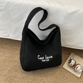 Minimalist black canvas tote bag featuring white letter print in a trendy hobo style - Black