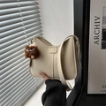 Beige half-moon crossbody bag with leather texture and cute monster plush pendant - White With Pom Pom Pendant