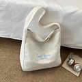 Minimalist off-white canvas tote bag with light blue lettering and wide shoulder straps - White