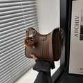 Deep brown fashion shoulder bag with matte leather finish and cute monster charm - Coffee With Pom Pom Pendant