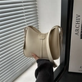 Chic beige crossbody bag featuring a minimalist FASHION patch and stitch detailing - White