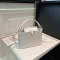 White faux leather crossbody bag with crocodile embossing and golden V-shaped hardware - White
