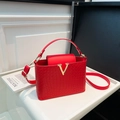 Red woven texture shoulder bag with gold V-buckle and adjustable crossbody strap - Red