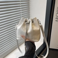 White oil-wax leather bucket bag with silver chain drawstring and pearl accents - White