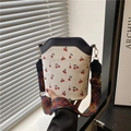 Contrast cherry print bucket bag with colorful geometric woven shoulder strap - Black