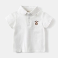 Detail of white cotton polo shirt featuring brown lucky bear embroidery and smooth buttons - 90 / White