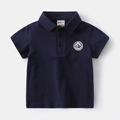Detail of navy blue boys polo shirt collar with buttons and embroidered chest patch - 90cm / Navy Blue