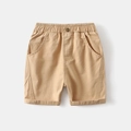 Close-up of boys' khaki cotton shorts with elastic waist and metal button detail - Khaki / 90cm