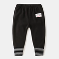 Thick black knitted kids pants with black and white striped ribbed ankle cuffs - Black