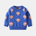 Detail of blue knitted boy's sweater featuring pink cartoon leopard jacquard and ribbed cuffs - Tag 90 / Blue Leopard