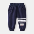 Detail view of navy blue kids joggers featuring white side stripes and ribbed cuffs - 100cm / Navy Blue