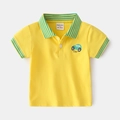 Flat lay of a yellow boys' short-sleeved cotton polo shirt with green car embroidery - Yellow / 90cm