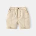 Beige cotton kids casual shorts featuring elastic waist and orange contrast stitching - 90cm / Light Khaki