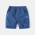 Detail view of elastic waist and navy cotton shorts with astronaut print and cargo pocket - 90cm / Royal Blue