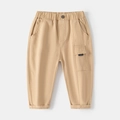 Boys beige cargo pants with elastic waist and stylish side pocket on grey background - 90cm / Khaki