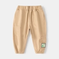 Kids khaki joggers with elastic waist and cute green dinosaur patch detail - Khaki / 90cm