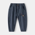 Detailed close-up of dark grey kids casual trousers with elastic waist and side pocket - Size 110 / Dark Blue