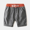 Detail of boys' grey knit shorts with orange elastic waistband and WAPYPY text print - 90cm / Dark Grey
