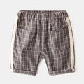 Detail view of boys' plaid cotton shorts featuring elastic waist and herringbone tape trim - 90cm / Coffee Plaid