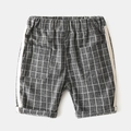 Detailed view of kids' grey checkered shorts featuring elastic waist and side stripes - 90cm / Dark Gray Plaid