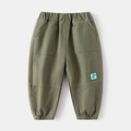 Pantaloni joggers verde oliva per bambini con elastico in vita e toppa con dinosauro - 90cm / Verde Militare