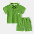 Detail of green cotton polo set for kids featuring white whale embroidery and elastic waist - Green